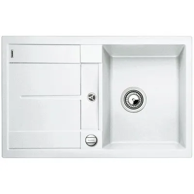 A white kitchen sink with a drainboard and a main basin.