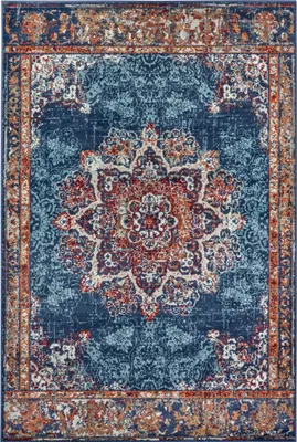 A top-down view of a rectangular rug with a distressed, ornate pattern.