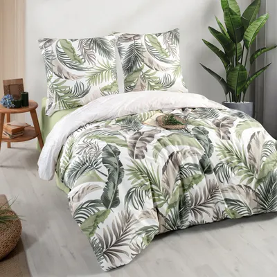 A bed with a duvet and pillows featuring a tropical palm leaf pattern.