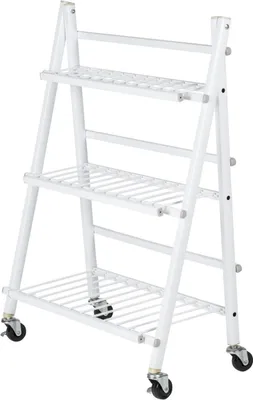 A white metal plant stand with three shelves and wheels.