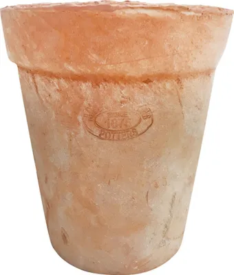 A close-up of a terracotta pot with an embossed logo.