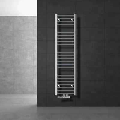 A modern bathroom setting with a chrome towel radiator mounted on a dark tiled wall.