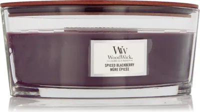 A WoodWick Spiced Blackberry scented candle in a clear glass jar with a wooden lid.