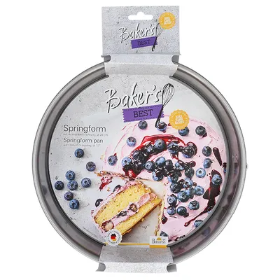 A springform cake pan with packaging, showing a slice of cake with blueberries and pink frosting.