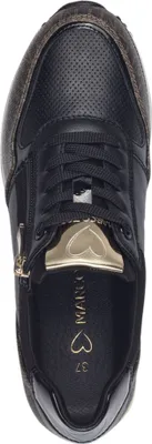 A top-down view of a black sneaker with gold accents.