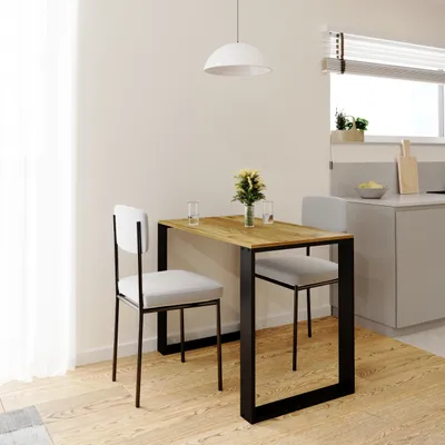 A small dining table with two chairs in a modern kitchen setting.