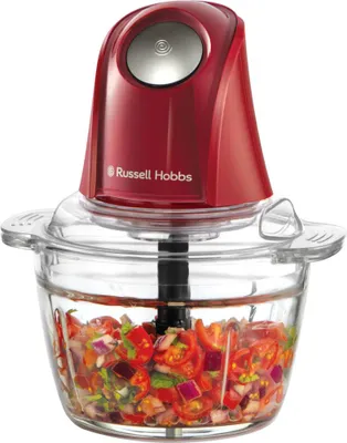 A red Russell Hobbs mini food chopper filled with chopped tomatoes, red onions, and herbs, shown against a white background.