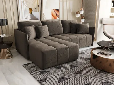 A modern living room with a sectional sofa, coffee table, and artwork.
