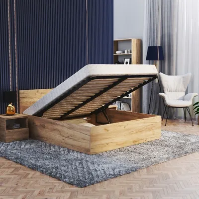 A bedroom scene with a bed with its storage open, a nightstand, a chair, and a bookshelf.