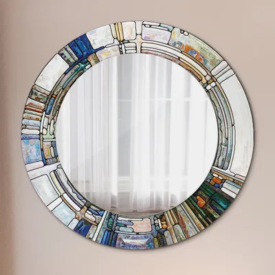 A round mirror with a decorative, abstract stained-glass-like frame.