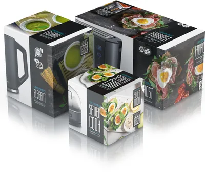 Three product boxes are arranged diagonally on a white reflective surface.