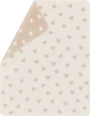 A baby blanket with a heart pattern, folded to show both sides.