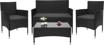 A black poly-rattan garden furniture set including a sofa, two chairs, and a coffee table, set against a white background.