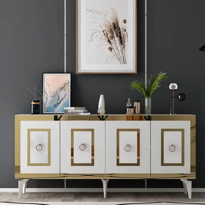 A white and gold sideboard with decorative items on top, set against a dark gray wall.