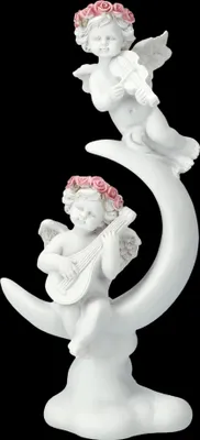 A white ceramic figurine of two cherubs playing musical instruments on a crescent moon.
