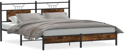 A bed frame with a headboard and footboard, made of wood and metal, with bedding on it.