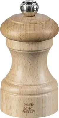 A close-up studio shot of a wooden pepper mill.