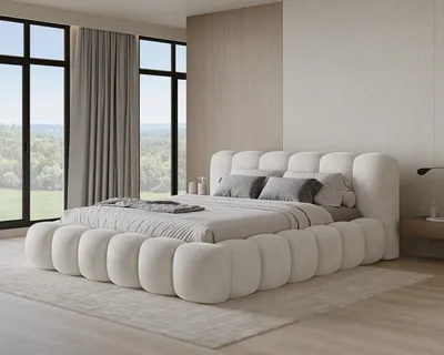 A modern bedroom with a large, plush bed and large windows overlooking a green landscape.