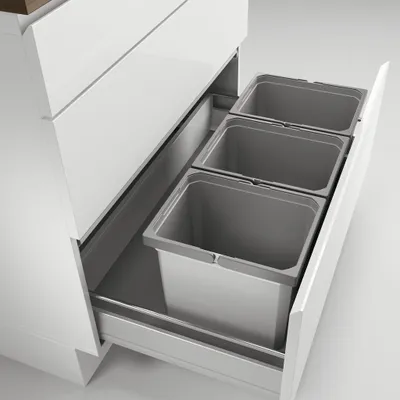 A pull-out kitchen cabinet drawer with three integrated waste bins.