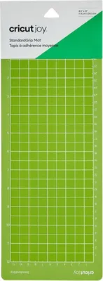 A Cricut Joy StandardGrip cutting mat is shown on a white background. The mat is green with a white grid pattern and measurement markings.