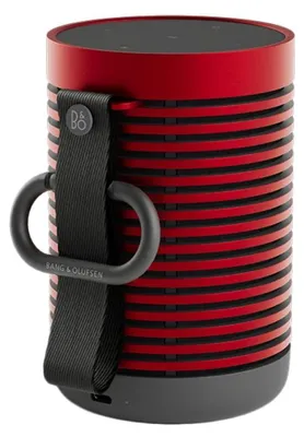 A close-up studio shot of a red and black portable speaker.