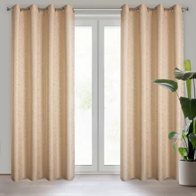 Two beige curtains hanging in front of a window.