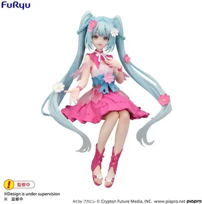 A 3D anime-style figurine of Hatsune Miku in a pink and white floral dress, posed sitting down against a white background.