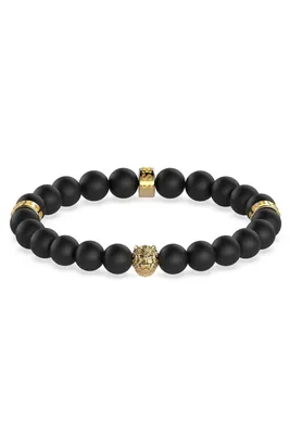 A bracelet with black beads and gold accents, including a lion's head charm.