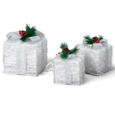 Three illuminated Christmas gift boxes decorated with pine cones and berries, set against a white background.