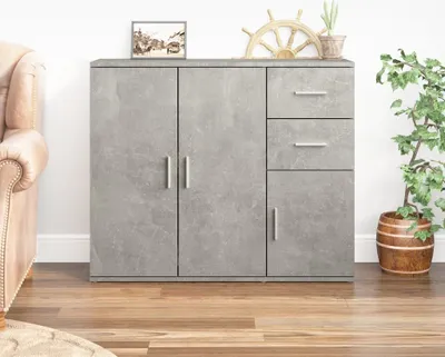 A gray sideboard with multiple drawers and doors, placed on a wooden floor next to a chair and a plant.