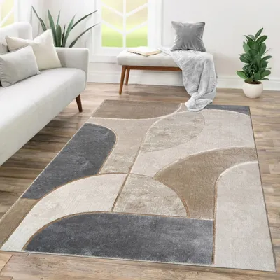 A modern living room with a sofa, rug, and bench.