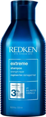 A blue bottle of Redken Extreme shampoo against a white background.