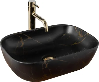 A black oval countertop sink with gold marble veining and a gold faucet.