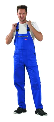 A man wearing blue overalls and a white t-shirt, standing against a white background.