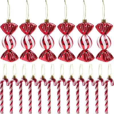 A collection of Christmas ornaments shaped like candy canes and wrapped candies, arranged in two rows against a white background.