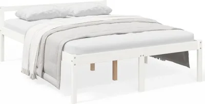 A white wooden bed frame with two pillows and a blanket.