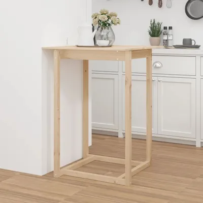 A tall, light-colored wooden bar table is shown against a white background with kitchen cabinets behind it.