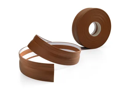 A roll of brown wood-effect PVC skirting board is shown, with a length unrolled and curved in front of the roll.