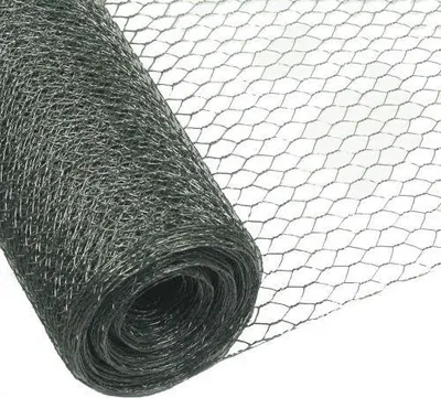 A roll of dark gray hexagonal wire mesh, also known as chicken wire, is shown against a white background. The mesh is partially unrolled, revealing its hexagonal pattern.