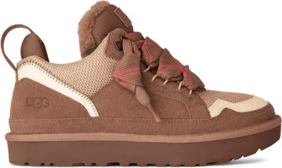 A side view of a brown UGG sneaker with cream and pink accents.