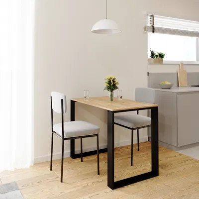 A small dining table with two chairs in a modern kitchen setting.