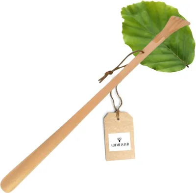 A wooden shoehorn with a leaf and a tag.