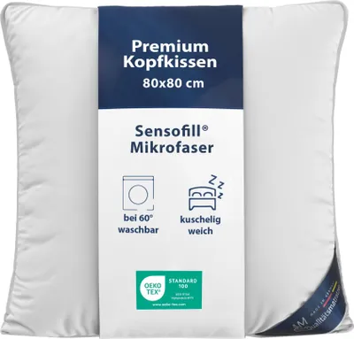 A white pillow with a dark blue label in the center.