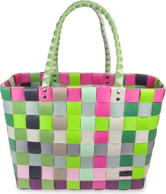 A colorful woven shopping basket against a white background.