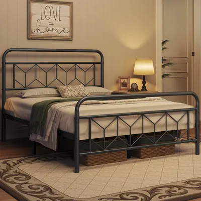 A bedroom scene with a black metal bed frame as the main focus.