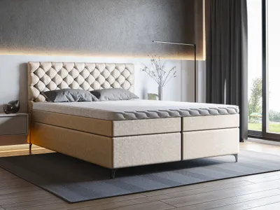 A modern bedroom with a large boxspring bed as the focal point.