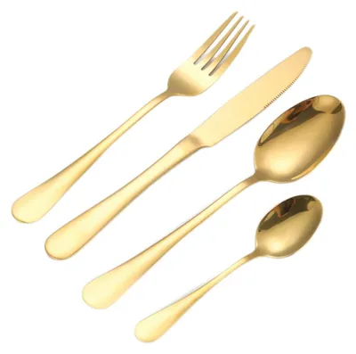 A set of gold-colored cutlery, including a fork, knife, and two spoons, arranged diagonally on a white background.