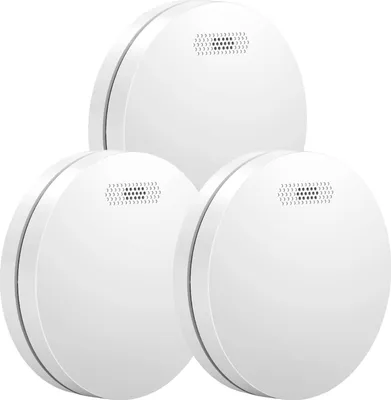 Three white smoke detectors are arranged in a cluster against a white background.