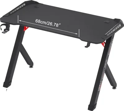 A black gaming desk shown from a slightly elevated front-left angle against a white background.