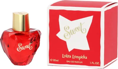 A red heart-shaped perfume bottle and its matching red box are displayed side-by-side on a white background.